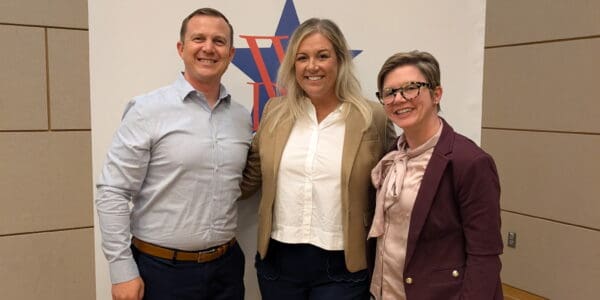 MDERS team members smiling at a conference, promoting disaster emergency response collaboration and resilience.