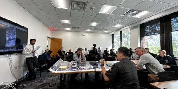 Emergency management training session at MDERS facility with diverse safety professionals and community leaders engaging in preparedness planning.