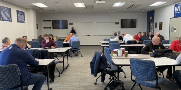 Participants engaged in an active threat tabletop exercise session focused on enhancing executive-level preparedness and response strategies for critical incident management.